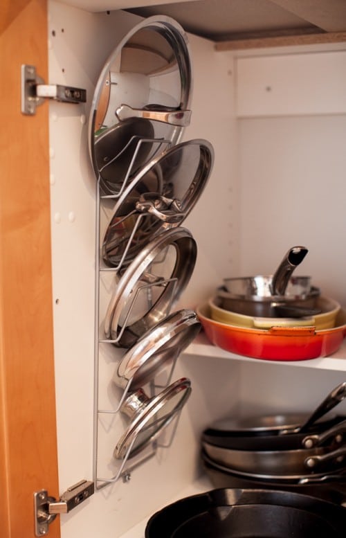 organize pot lids by hanging a rack inside the cupboard on simplebites.net
